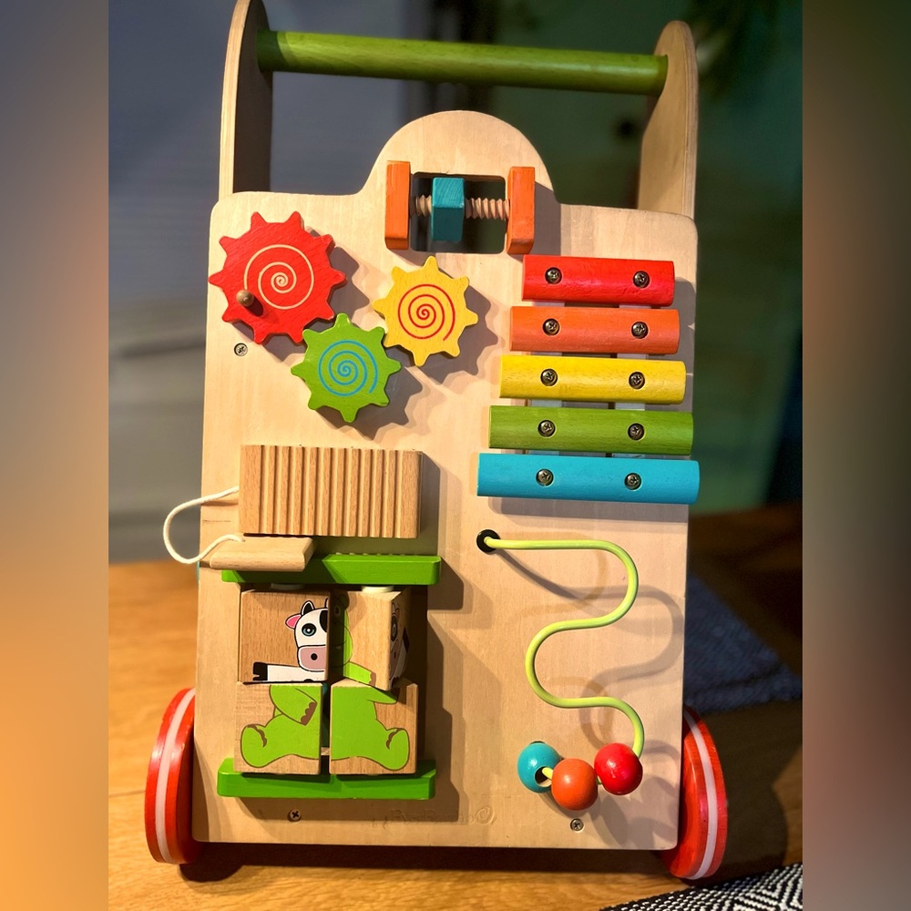 Activity walker. Beautiful classic wood wheeled busyboard